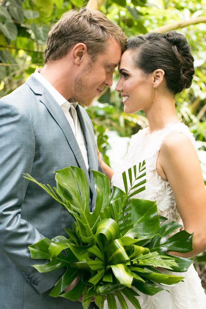 bride and groom pose close for portrait