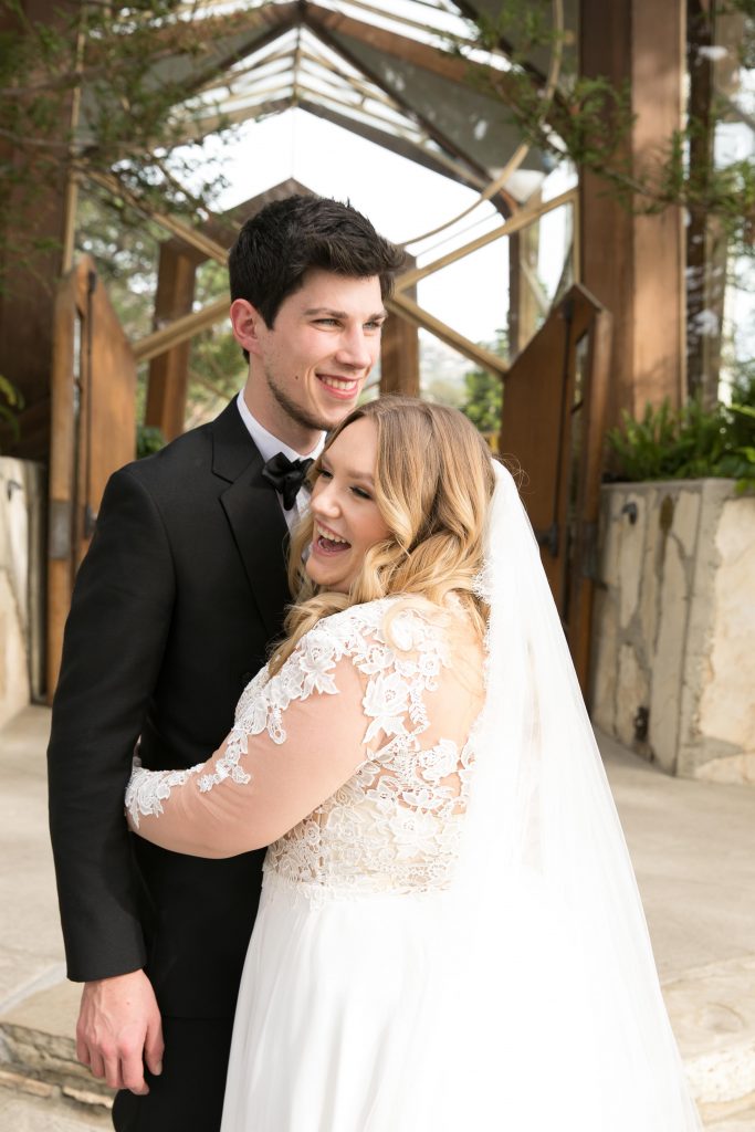 bride and groom photograph in front of Wayfarers chapel