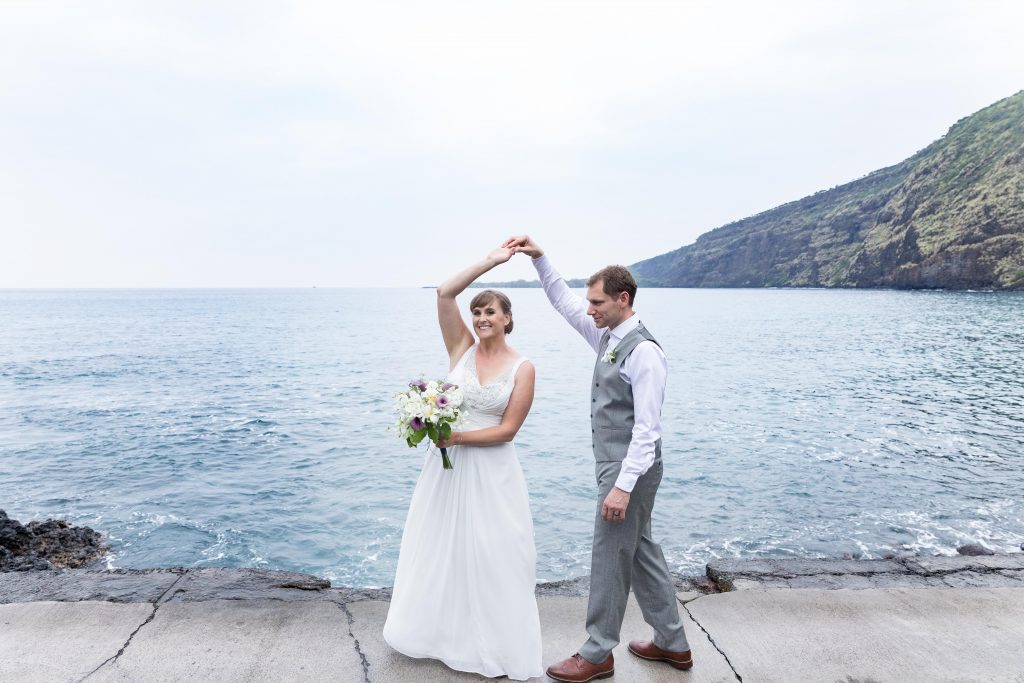 couple dance in front of the ocean Kealakekua Bay Wedding Venue