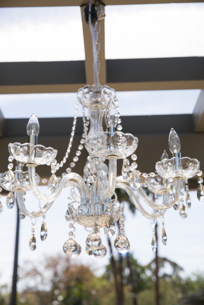 glass chandelier at garden wedding