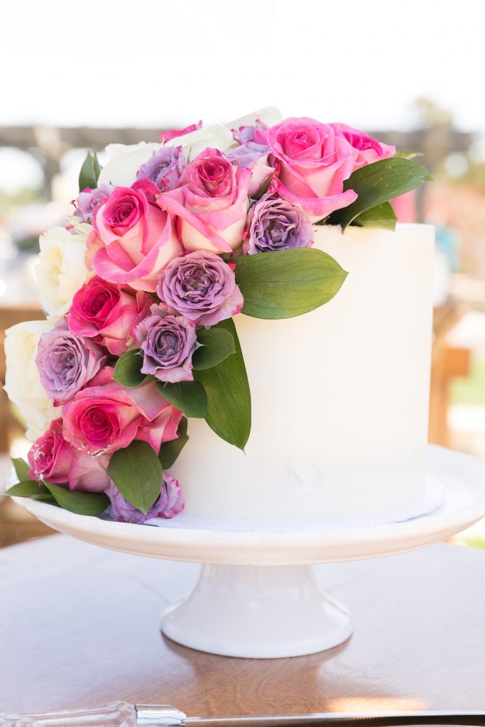 wedding cake with purple and pink flowers