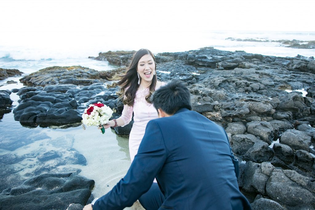bride laughs ocean rocks