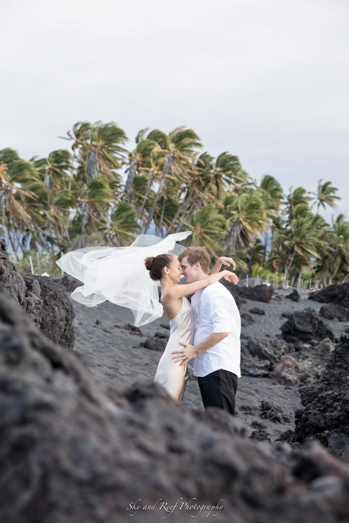 bride and groom kiss on the beach after their elopement