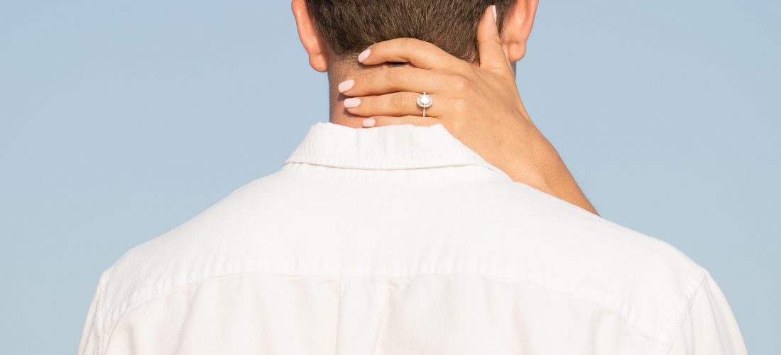 engagement ring on grooms neck
