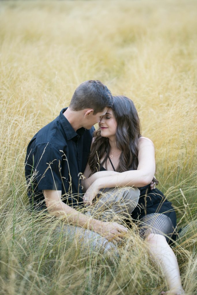couple sitting together in field