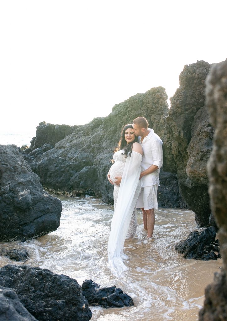 maui maternity couple in rocks beach