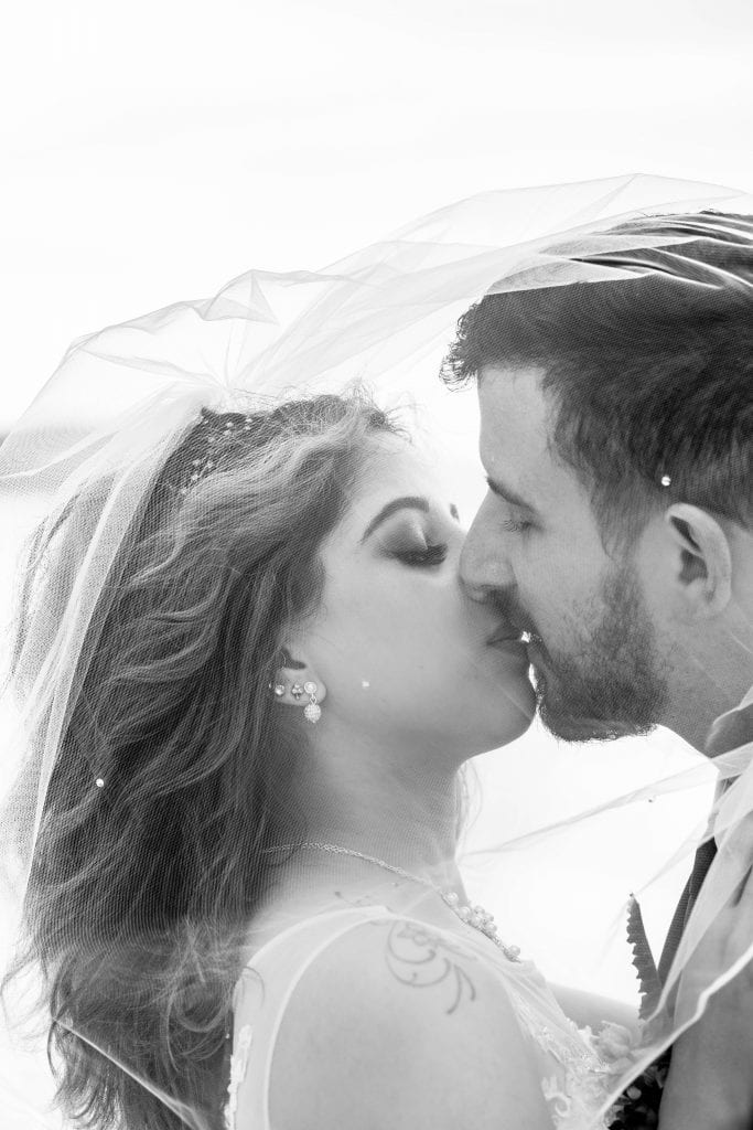 bw bride and groom kiss